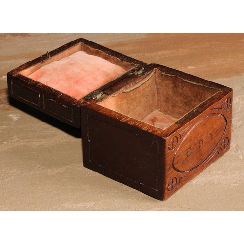 440 - An Arts and Crafts oak rectangular box or caddy, the hinged cover carved with a stylised apple tree,... 