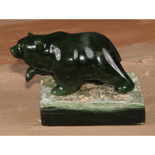 135 - A Canadian Inuit nephrite jade carving, of a bear, rectangular base, 8.5cm high