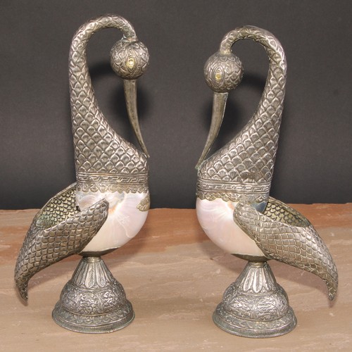 349 - A pair of Tibetan/Nepalese silver coloured metal mounted pearl nautilus shell models, of birds, chas... 