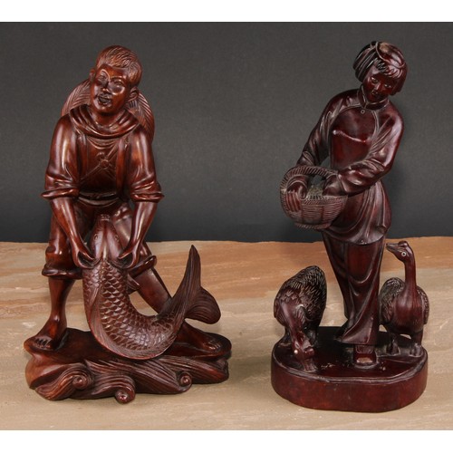 321 - A pair of Chinese hardwood figures, carved as a young fisherman and a girl feeding geese, 25.5cm and... 