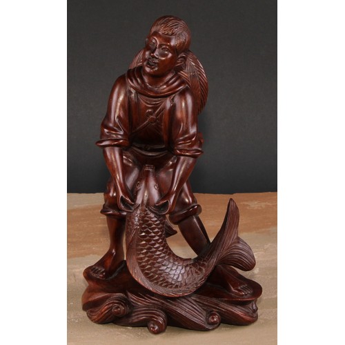 321 - A pair of Chinese hardwood figures, carved as a young fisherman and a girl feeding geese, 25.5cm and... 