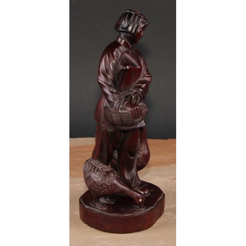 321 - A pair of Chinese hardwood figures, carved as a young fisherman and a girl feeding geese, 25.5cm and... 