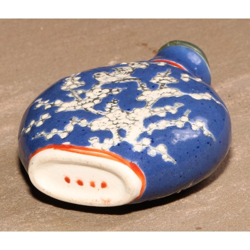 170 - A Chinese porcelain flatenned ovoid snuff bottle, moulkded and decorated in polychrome enamels with ... 