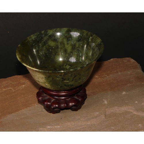 179 - A Chinese spinach jade bowl, 10cm diam, hardwood stand