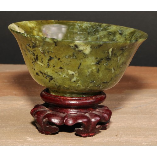 179 - A Chinese spinach jade bowl, 10cm diam, hardwood stand