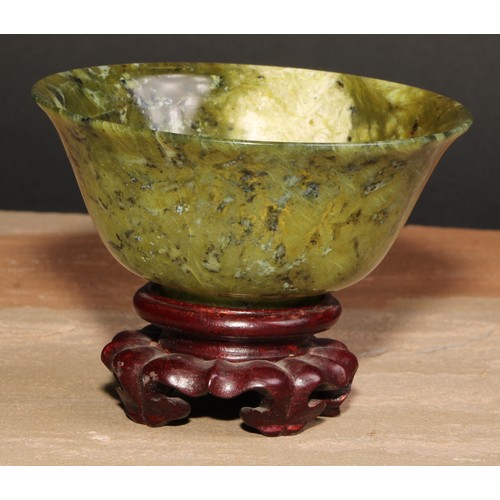 179 - A Chinese spinach jade bowl, 10cm diam, hardwood stand