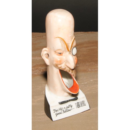 230 - A German porcelain novelty caricature spill holder, For He's a Jolly Good Fellow...', 13.5cm high, c... 