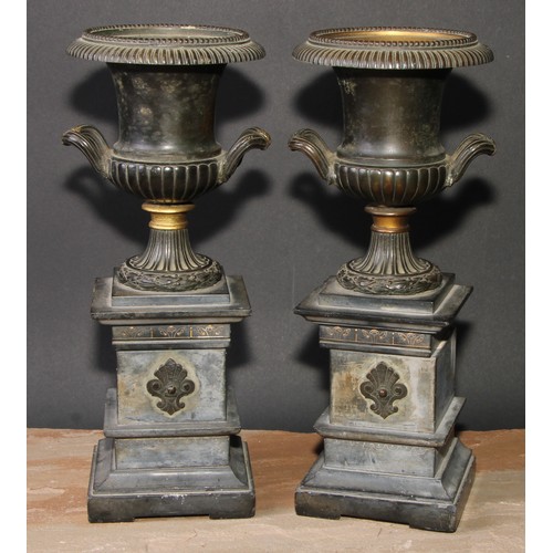 309 - A pair of 19th century dark patinated bronze half fluted campana mantel urns, beaded borders, wrappe... 