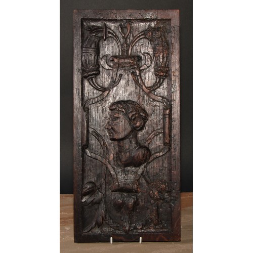 10 - A 16th/17th century oak Romayne panel, carved in relief with a portrait bust, scrolls and strapwork,... 