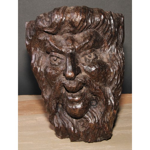 84 - A 19th century oak wall boss or mask, carved in the Baroque manner as the head of a lady, 28.5cm hig... 