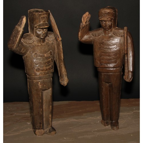 555 - Folk Art - a pair of carved  figures, Napoleonic soldiers, each standing to attention, 41cm high, 19... 