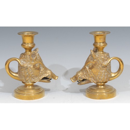 310 - A pair of 19th century gilt brass novelty candlesticks, cast as boars’ heads, looped tail handles, c... 