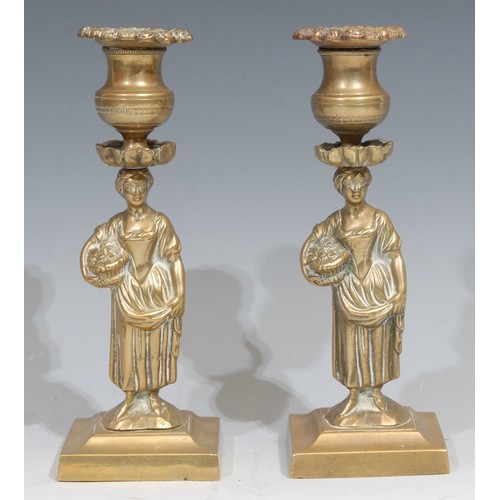 348 - A pair of Regency bronze figural candlesticks, each cast as a young lady gathering flowers, spreadin... 