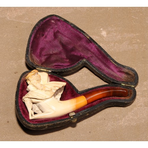 264 - A late 19th century meerschaum pipe, carved as a lady of wearing a flowing skirt, 8.5cm long, cased