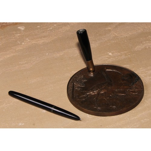 129 - A bronze desk top pen stand, cast in relief in the Aesthetic Movement Japanese taste with a stork, 1... 