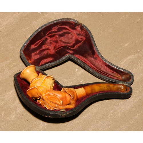 263 - A late 19th century meerschaum pipe, carved as a hand holding a rose, 11cm long, cased