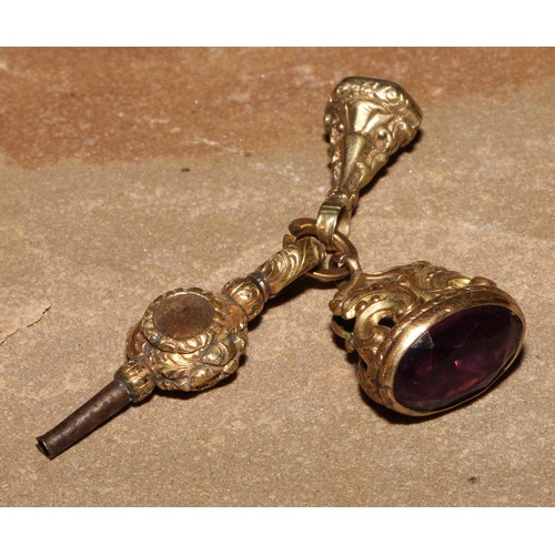 54 - A 19th century gilt metal fob, set with an amethyst, 2.5cm long; another; a gilt metal pocket watch ... 