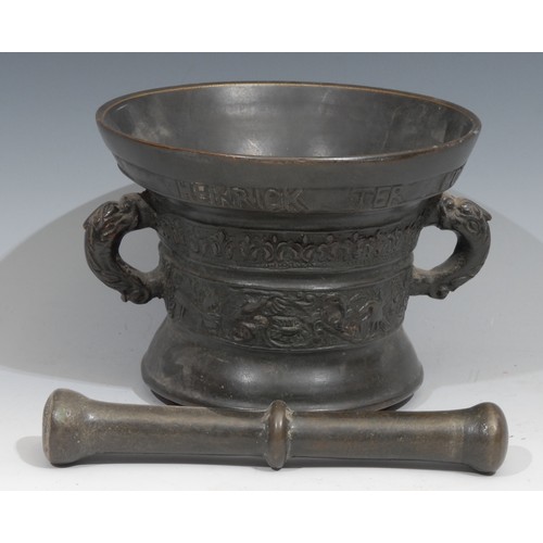 207 - A Dutch bronze pestle and mortar, cast with birds and scrolling foliage, inscribed beneath the rim H... 