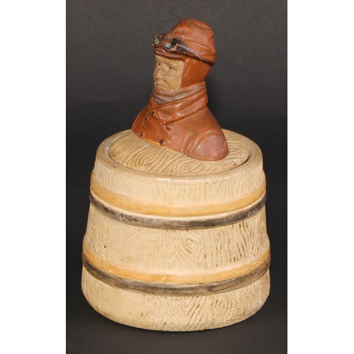 467 - An early 20th century stoneware novelty tobacco jar, the cover with a vintage motorist, bust length,... 