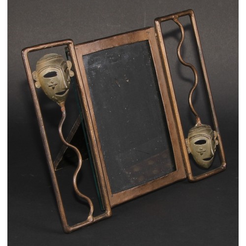 428 - An Art Deco period painted metal easel photograph frame, the rectangular aperture flanked by African... 