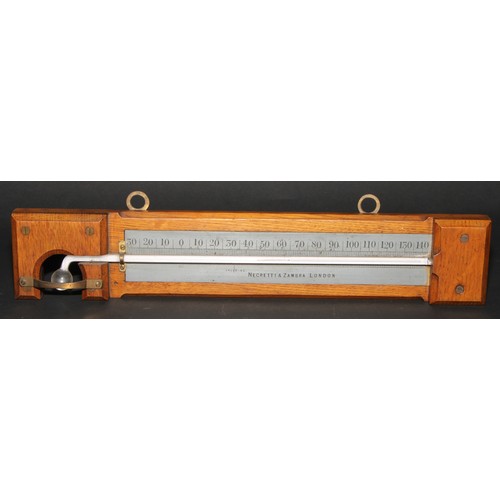 293 - A Negretti & Zambra minimum self-registering thermometer, silvered register, oak mount, 35.5cm long