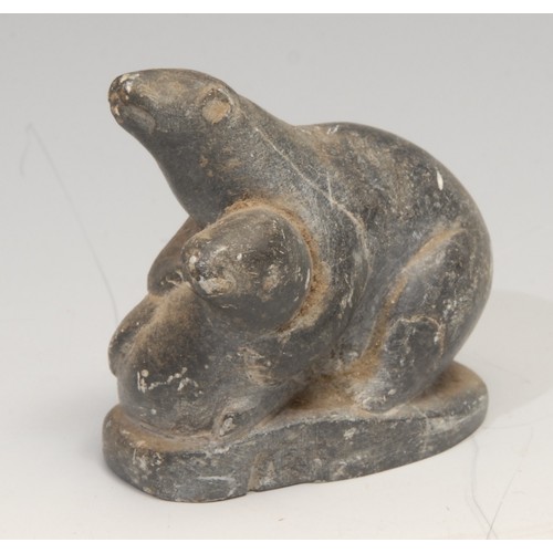 825 - An Inuit soapstone carving, of a hunter and a seal, 21cm long, label for Canadian Inuit Art, mid 20t... 