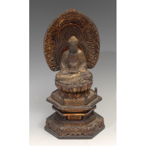 159 - A Chinese lacquer shrine figure, of Buddha, seated within a lotus, hexagonal base, 26.5cm high