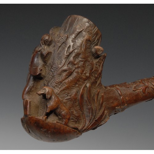 251 - A large Black Forest pipe, the bowl carved with a sportsman and his dog, 44cm long, c.1880