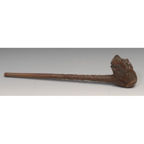 251 - A large Black Forest pipe, the bowl carved with a sportsman and his dog, 44cm long, c.1880