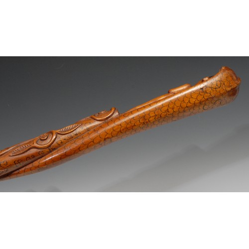 747 - An Indian walking stick, carved with a figure and a cobra, the entwined shaft with a meandering flow... 