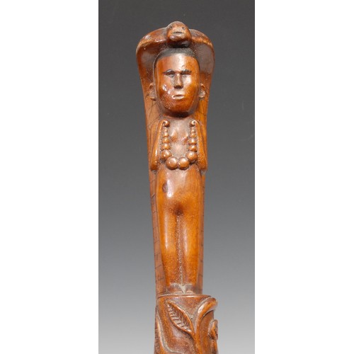 747 - An Indian walking stick, carved with a figure and a cobra, the entwined shaft with a meandering flow... 