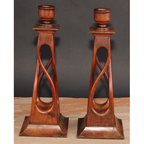 675 - Treen - a pair of unusual mahogany square open-twist table candlesticks, spreading bases, 34cm high,... 