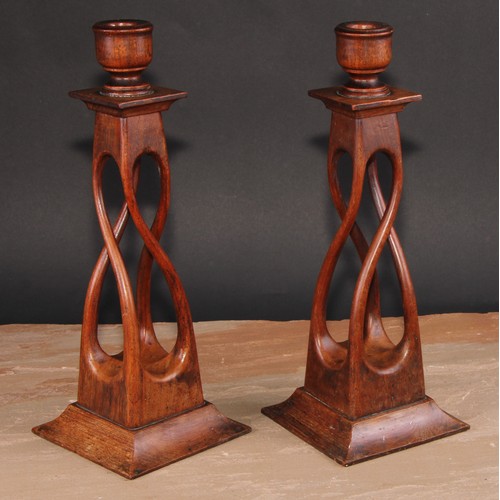 675 - Treen - a pair of unusual mahogany square open-twist table candlesticks, spreading bases, 34cm high,... 