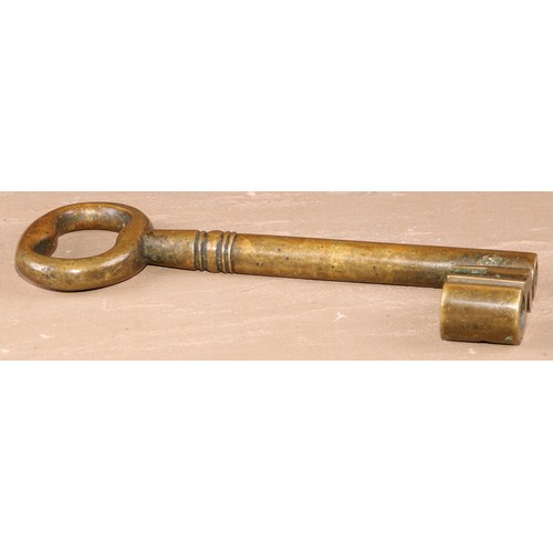 533 - Copoclephily - a large 19th century bronze key, possibly from an arsenal or gunpowder store, elabora... 