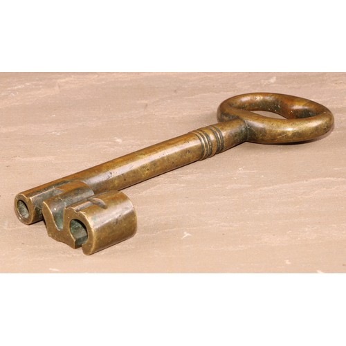 533 - Copoclephily - a large 19th century bronze key, possibly from an arsenal or gunpowder store, elabora... 