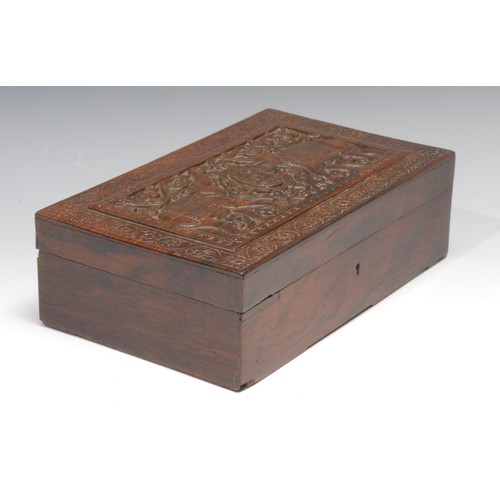 491 - An Indian hardwood rectangular box, hinged cover carved with elephants and initials RSB, within a bo... 