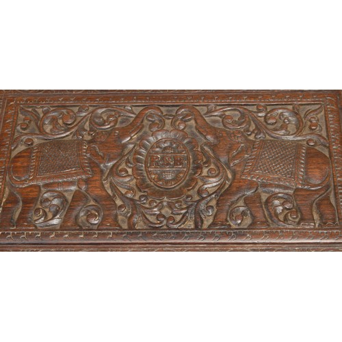 491 - An Indian hardwood rectangular box, hinged cover carved with elephants and initials RSB, within a bo... 