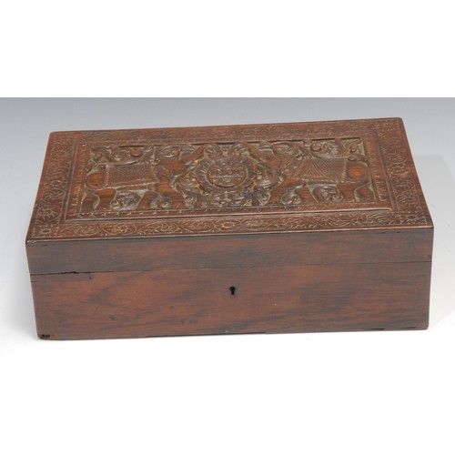 491 - An Indian hardwood rectangular box, hinged cover carved with elephants and initials RSB, within a bo... 