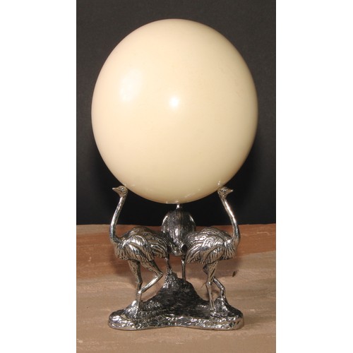 632 - Natural History and the Cabinet of Curiosities - an ostrich egg, the silver plated triform base cast... 