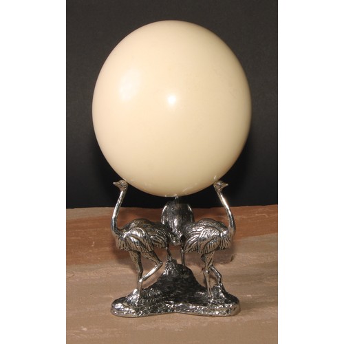 632 - Natural History and the Cabinet of Curiosities - an ostrich egg, the silver plated triform base cast... 