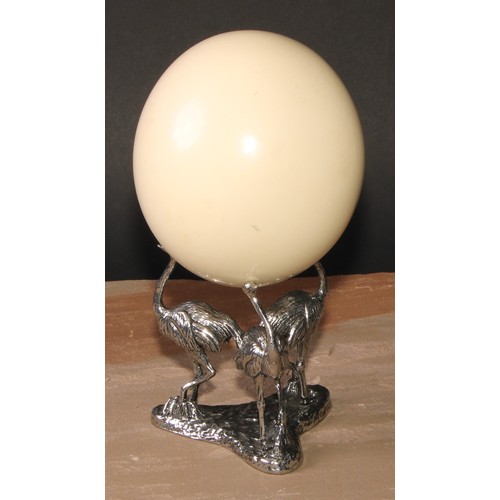 632 - Natural History and the Cabinet of Curiosities - an ostrich egg, the silver plated triform base cast... 