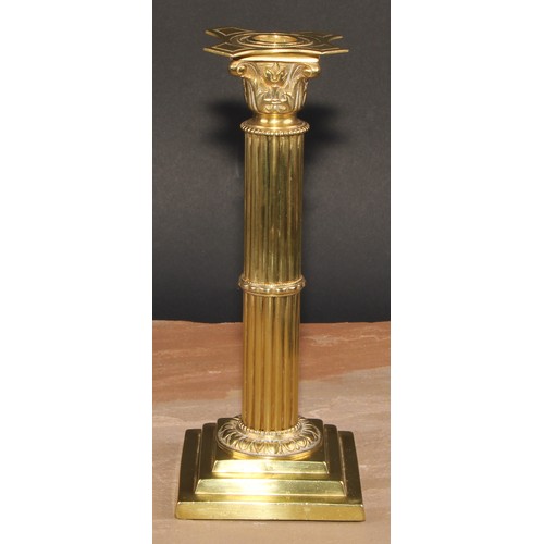 693 - A pair of brass Corinthian column candlesticks, detachable nozzles, fluted columns, stepped square b... 