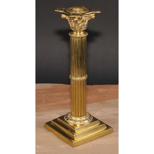 693 - A pair of brass Corinthian column candlesticks, detachable nozzles, fluted columns, stepped square b... 