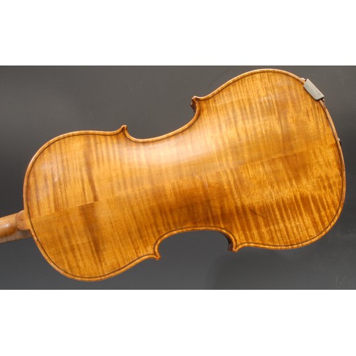 401 - A violin, the two-piece back 35.75cm long excluding button, ebonised tuning pegs, outlined throughou... 