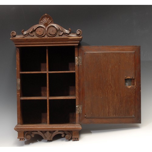 38 - A 19th century Continental oak wall hanging hall cabinet, in the Renaissance Revival taste, shaped a... 