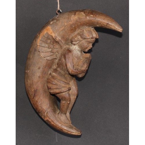 501 - An Italian softwood carving, of a putto musician, serenading within the crescent moon, 31cm high