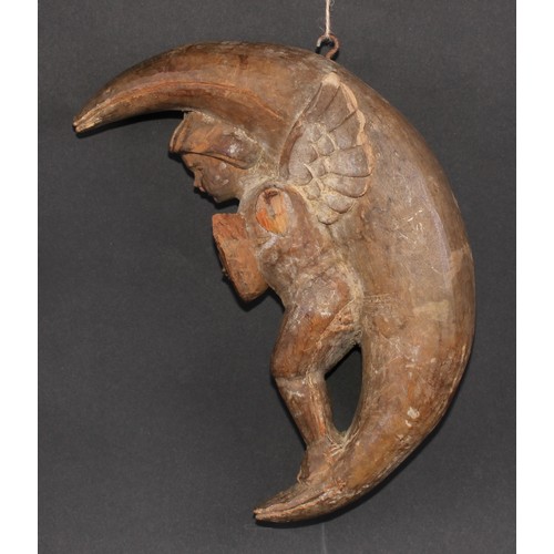 501 - An Italian softwood carving, of a putto musician, serenading within the crescent moon, 31cm high