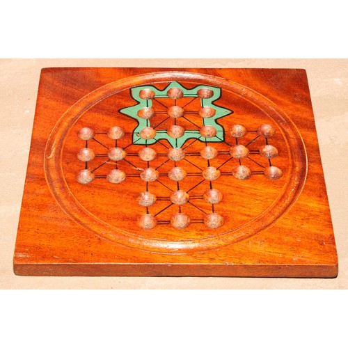 71 - A 19th century mahogany double-sided solitaire board, 15.5cm wider, marbles en suite