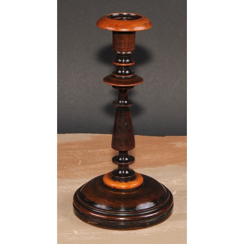 674 - Treen - a pair of turned fruitwood candlesticks, 24cm high