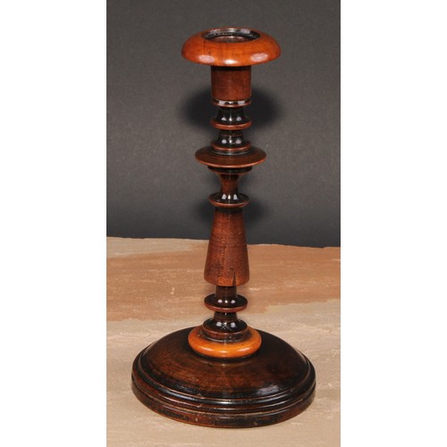 674 - Treen - a pair of turned fruitwood candlesticks, 24cm high